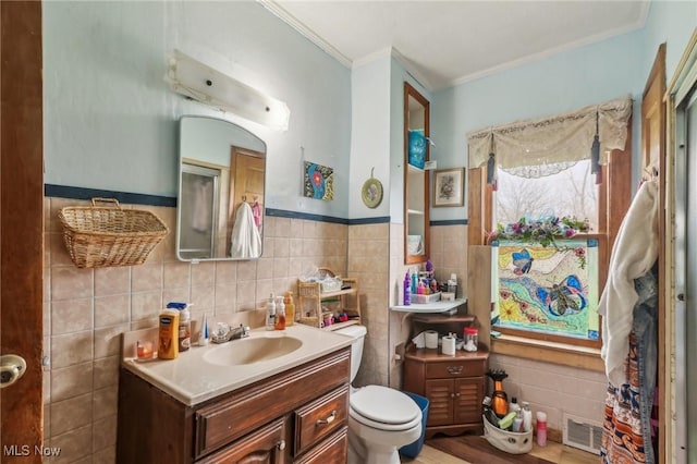 944 Bey Rd, Akron, OH 44312 - bathroom featuring tile walls, vanity, crown molding, and wainscoting