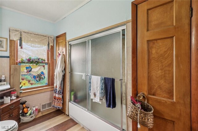 944 Bey Rd, Akron, OH 44312 - full bathroom with wood finished floors, ornamental molding, and combined bath / shower with glass door