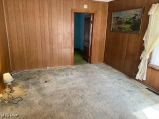 944 Bey Rd, Akron, OH 44312 - spare room featuring wooden walls and carpet flooring
