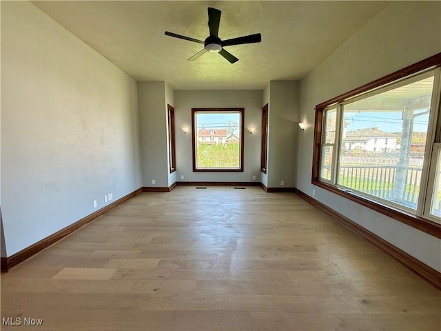 609 Main St, Toronto, OH 43964 - empty room featuring light wood-style floors, plenty of natural light, baseboards, and a ceiling fan