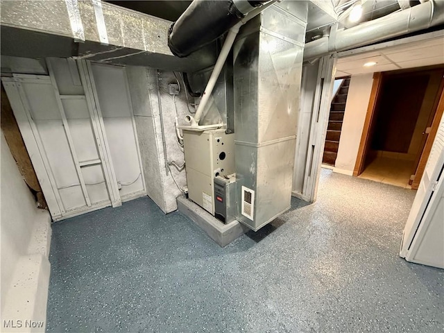 utility room featuring heating unit