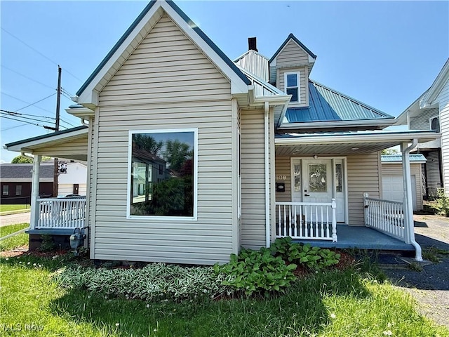 609 Main St, Toronto, OH 43964 - view of front of home with covered porch and a garage