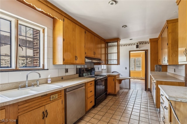 kitchen featuring a sink, black electric range, dishwasher, light countertops, and under cabinet range hood