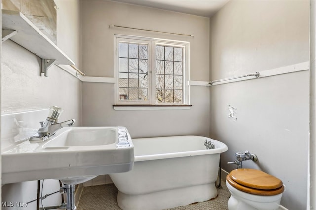 bathroom featuring a soaking tub and tile patterned floors