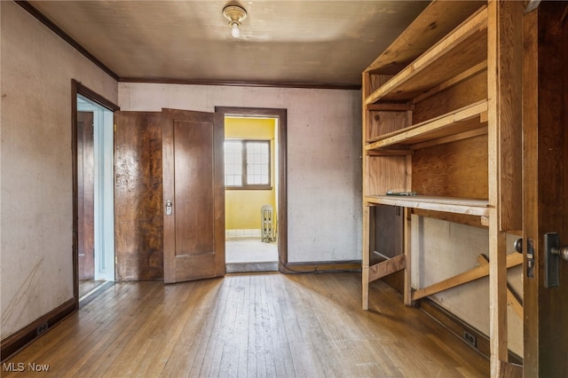 interior space with radiator heating unit and hardwood / wood-style flooring
