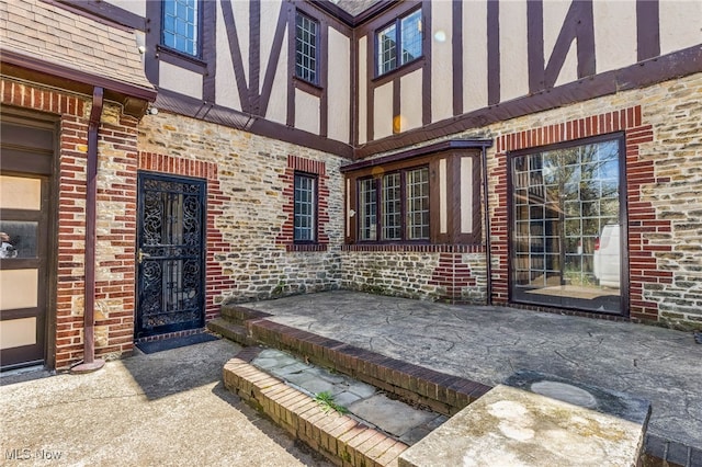 view of exterior entry featuring brick siding