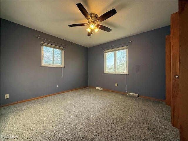 9083 Priem Rd, Strongsville, OH 44149 - carpeted empty room featuring plenty of natural light, visible vents, baseboards, and ceiling fan