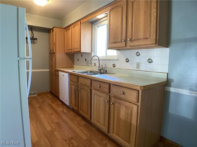 9083 Priem Rd, Strongsville, OH 44149 - kitchen featuring light countertops, decorative backsplash, a sink, and white appliances
