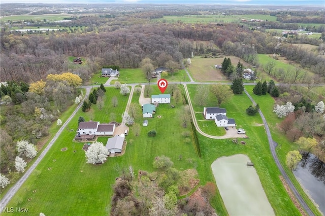 drone / aerial view featuring a forest view