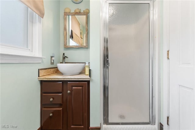 full bathroom with vanity and a stall shower