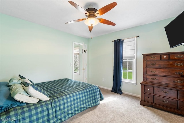 bedroom with baseboards, light colored carpet, and ceiling fan