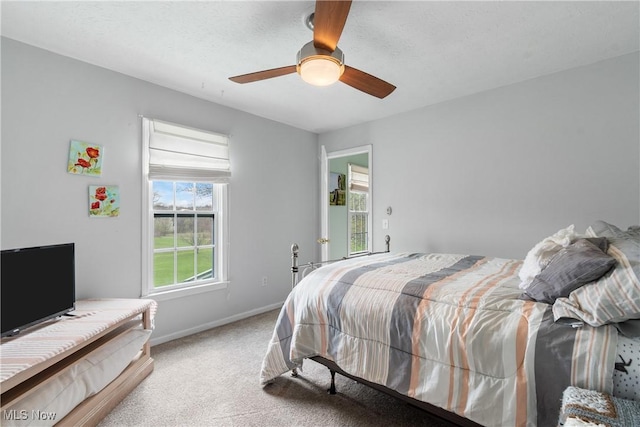 bedroom with ceiling fan, baseboards, and carpet