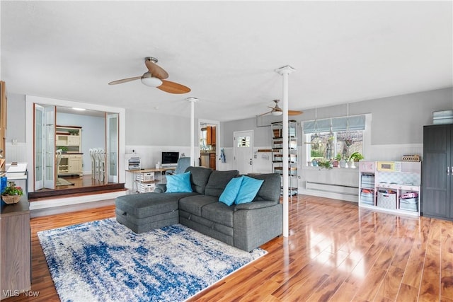 living room with a ceiling fan and wood finished floors