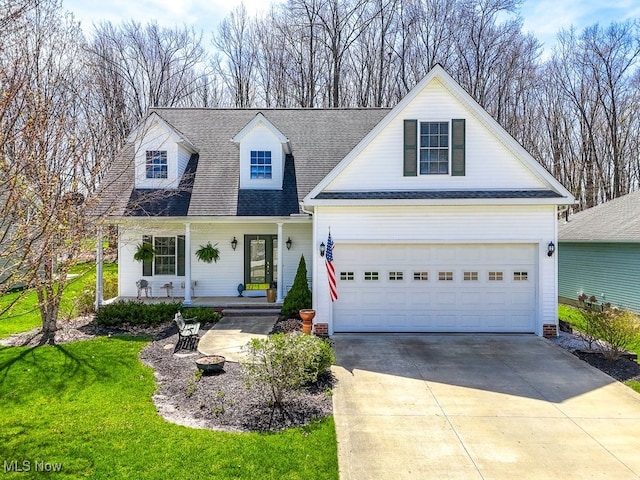 new england style home with a front lawn, driveway, a shingled roof, and covered porch