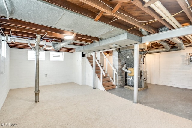 below grade area with heating unit and stairway