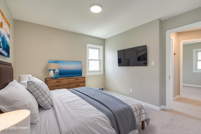 bedroom with baseboards, carpet flooring, and multiple windows