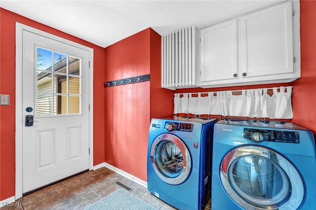 laundry area with visible vents, baseboards, tile patterned flooring, cabinet space, and washer and dryer