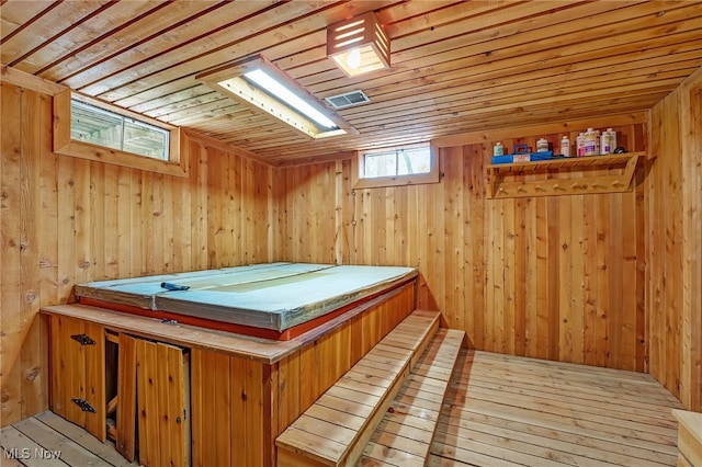 interior space with wood ceiling, hardwood / wood-style floors, wooden walls, and a sauna