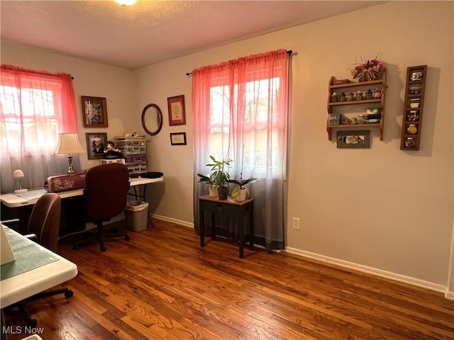home office featuring baseboards, wood finished floors, and a textured ceiling