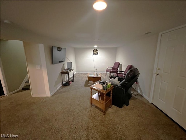 carpeted living room with baseboards and stairs