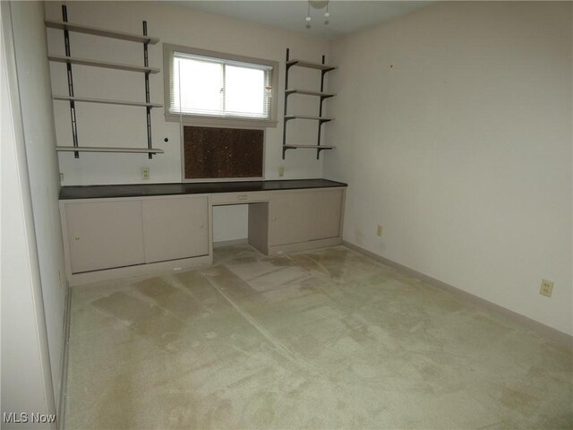 403 Sandy Dr, Cambridge, OH 43725 - unfurnished office featuring light carpet, built in study area, and baseboards