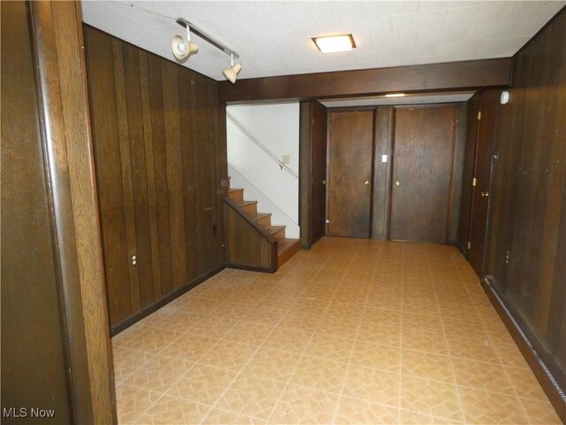 403 Sandy Dr, Cambridge, OH 43725 - hallway with wood walls, light flooring, and stairs