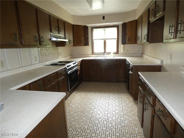 403 Sandy Dr, Cambridge, OH 43725 - kitchen with under cabinet range hood, range with electric stovetop, light countertops, a sink, and backsplash