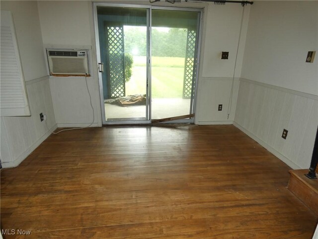 403 Sandy Dr, Cambridge, OH 43725 - empty room with a wainscoted wall, wood finished floors, and a wall mounted AC