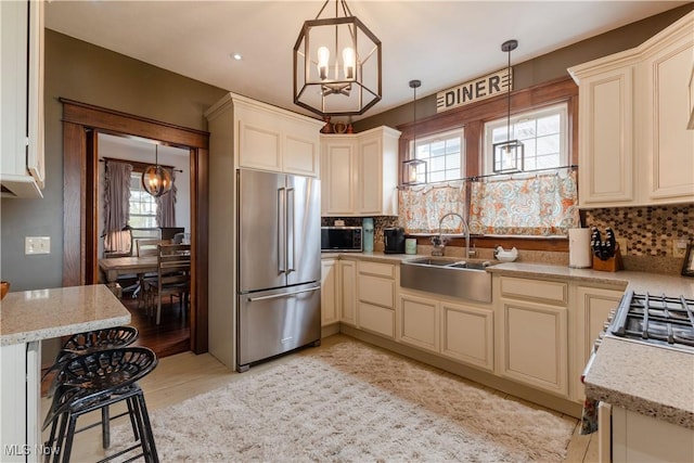 353 W N Ave, East Palestine, OH 44413 - kitchen featuring stainless steel appliances, a chandelier, a sink, tasteful backsplash, and recessed lighting