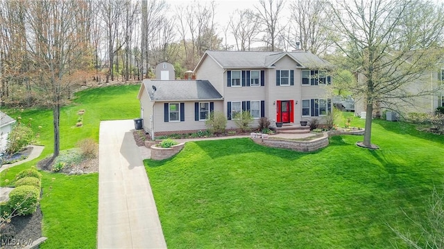 colonial house with driveway and a front yard
