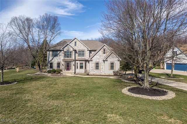 traditional-style home with stone siding and a front yard