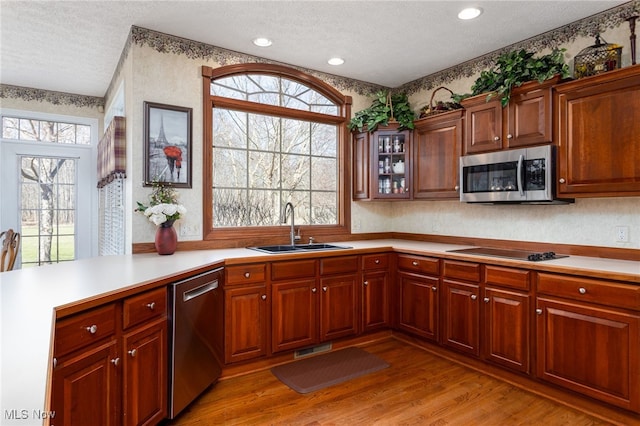 kitchen featuring light countertops, visible vents, a sink, a textured ceiling, and appliances with stainless steel finishes