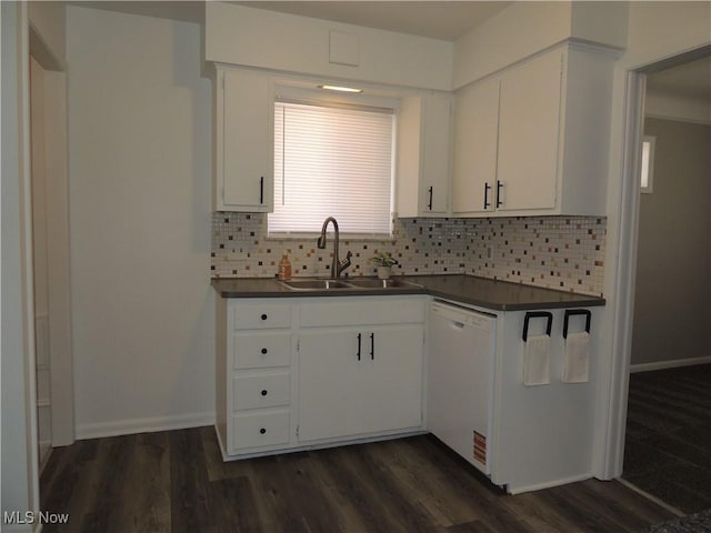 kitchen featuring dark countertops, tasteful backsplash, a sink, dishwasher, and white cabinets