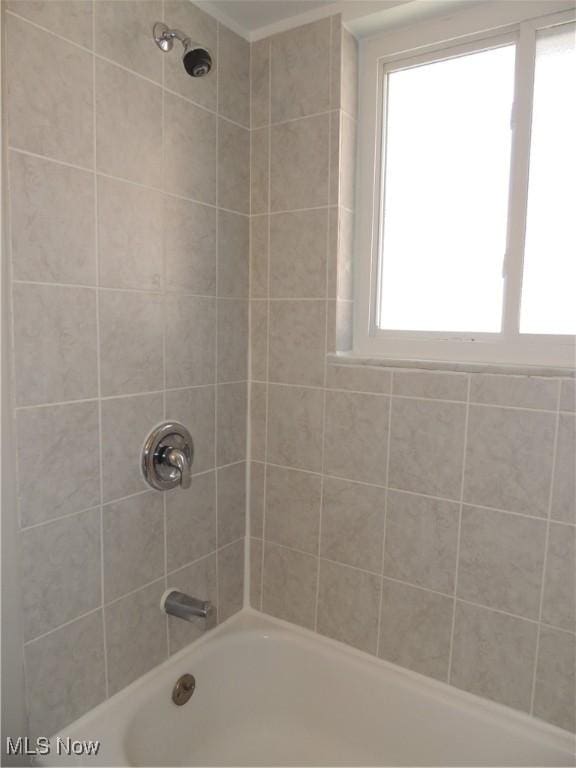 bathroom featuring a wealth of natural light and shower / bath combination