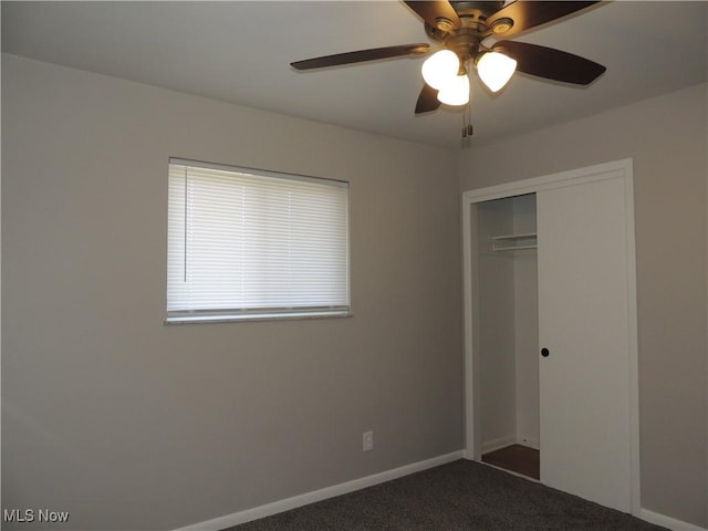 unfurnished bedroom featuring baseboards, carpet, a closet, and ceiling fan
