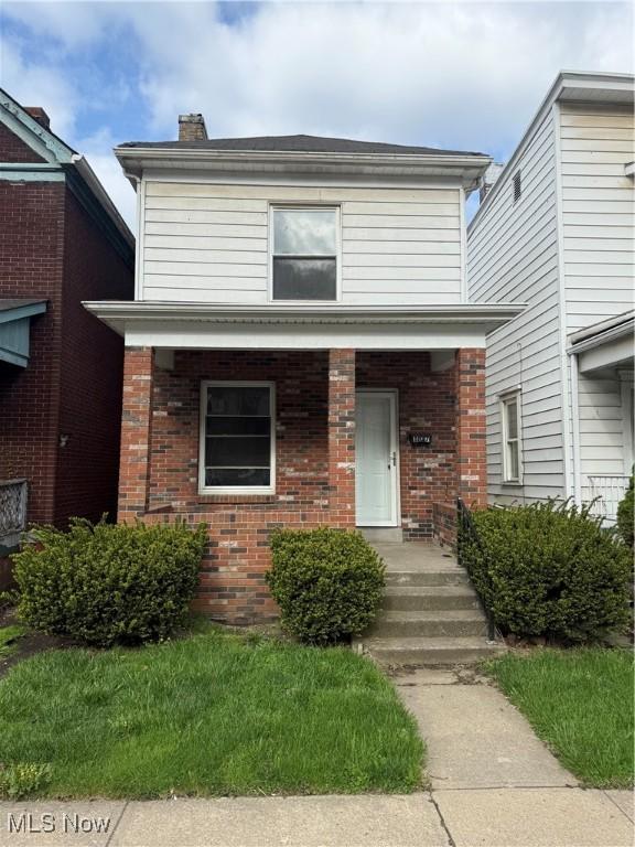 807 Virginia Ave, Follansbee, WV 26037 - view of front of home with a chimney and brick siding