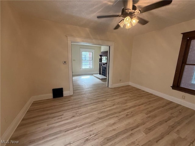 807 Virginia Ave, Follansbee, WV 26037 - unfurnished room with wood finished floors, a textured ceiling, a ceiling fan, and baseboards