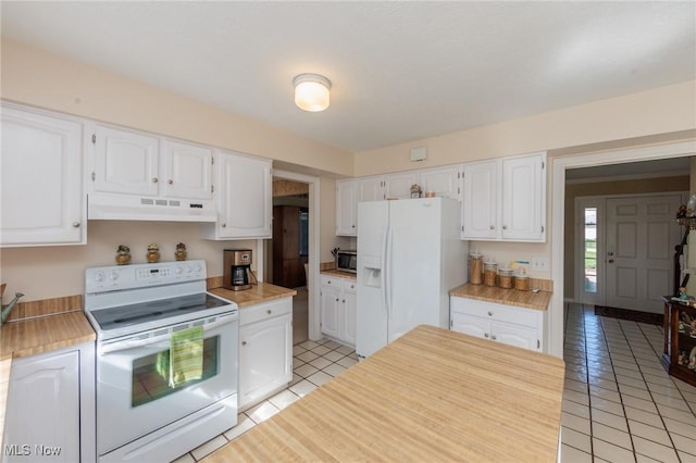 kitchen with light tile patterned flooring, light countertops, under cabinet range hood, and white appliances