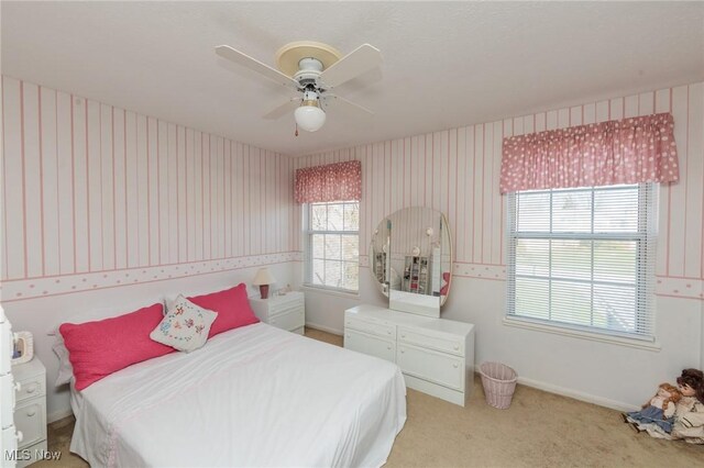 carpeted bedroom featuring ceiling fan, baseboards, and wallpapered walls