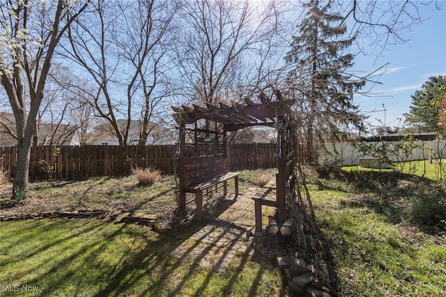 view of yard with a pergola and a fenced backyard