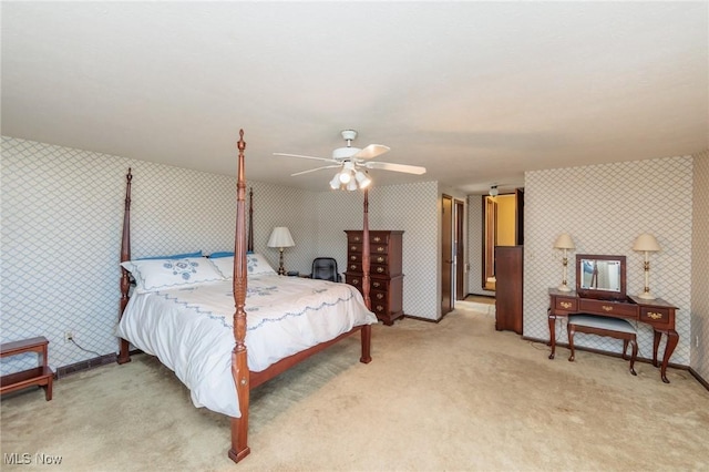 bedroom featuring wallpapered walls, baseboards, and light carpet
