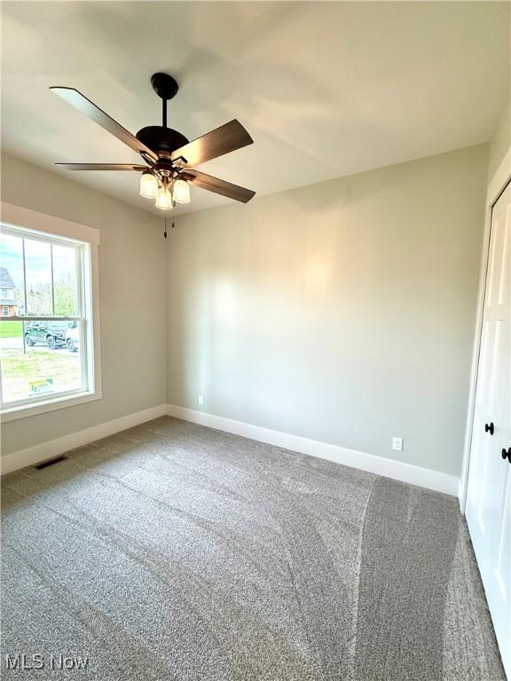 6028 Arlyne Ln, Medina, OH 44256 - empty room featuring carpet floors, visible vents, baseboards, and ceiling fan