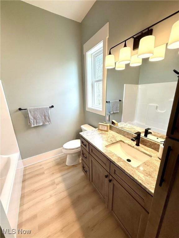 6028 Arlyne Ln, Medina, OH 44256 - bathroom with baseboards, wood finished floors, vanity, and toilet