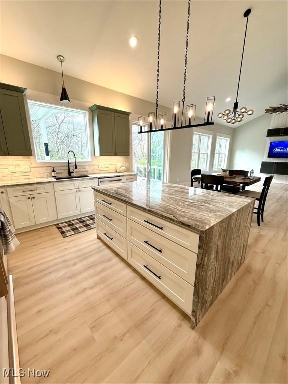 6028 Arlyne Ln, Medina, OH 44256 - kitchen with light wood-type flooring, an inviting chandelier, and a sink