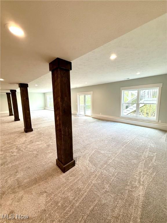 below grade area featuring baseboards, carpet flooring, and recessed lighting