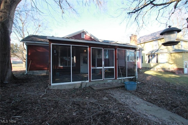 224 E Pine St, Lisbon, OH 44432 - rear view of property with a chimney and a sunroom