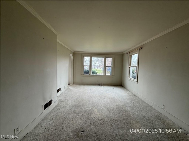 224 E Pine St, Lisbon, OH 44432 - carpeted empty room featuring baseboards, visible vents, arched walkways, and ornamental molding
