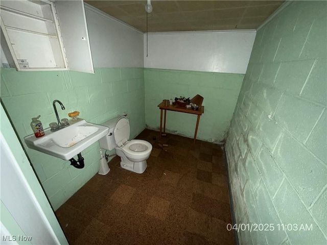 224 E Pine St, Lisbon, OH 44432 - half bath with concrete block wall, tile patterned floors, and toilet