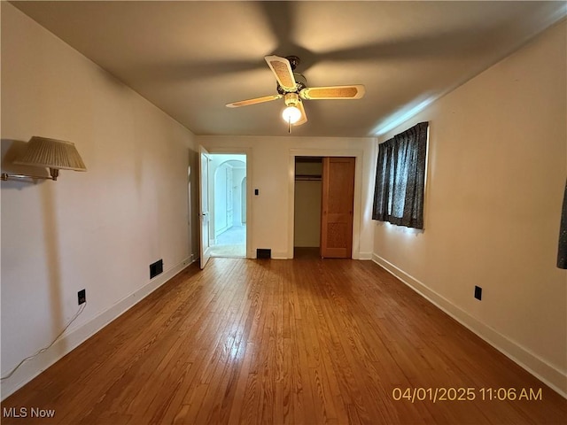 224 E Pine St, Lisbon, OH 44432 - unfurnished bedroom with wood finished floors, visible vents, a closet, baseboards, and ceiling fan