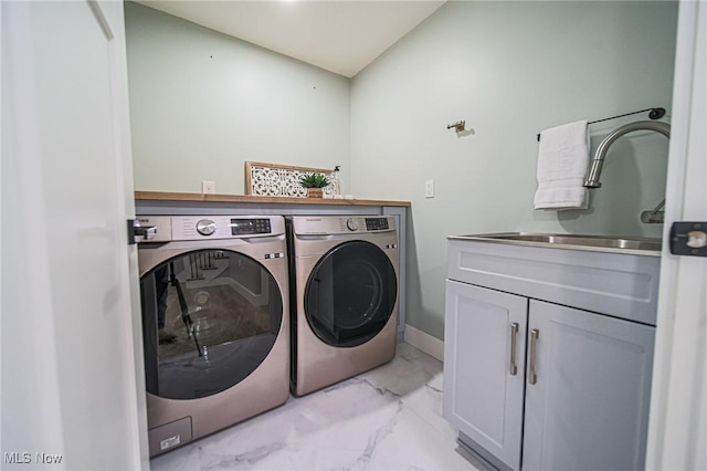 laundry area featuring marble finish floor, a sink, washing machine and clothes dryer, baseboards, and cabinet space